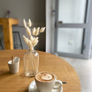 A comforting coffee experience in a minimalist café setting, perfect for a relaxed morning or coffee break.