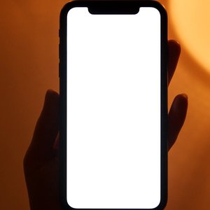 Smartphone with blank screen held by a hand, perfect for app or design mockups.