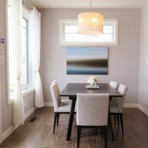 A bright, contemporary dining room with minimalist decor and modern furnishings.