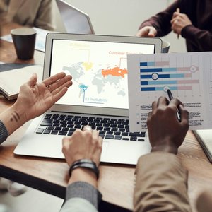 Professional team discussing analytics and brainstorming ideas in a meeting room.