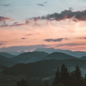 Tranquil view of Brixen im Thale mountains at sunset, capturing serene natural beauty.