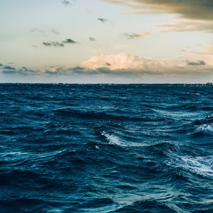 A captivating view of ocean waves under a dramatic twilight sky, offering a peaceful seascape.