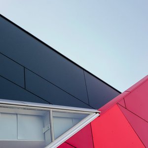 A low-angle view of a modern geometric building facade with bold colors in London, ON, Canada.