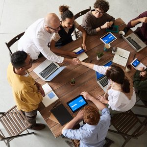 Overhead shot of a diverse team collaborating in a modern office meeting.