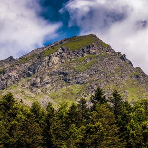 Beautiful view of a rocky mountain under a clear blue sky in Occitanie, France.