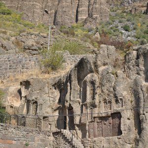 Explore intricate ancient rock carvings set against a majestic mountain background.