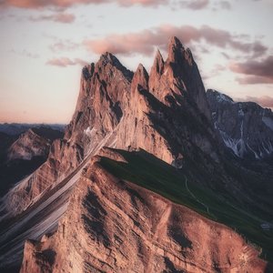 Breathtaking view of the sharp peaks of Seceda in the Dolomites during twilight, highlighting natural beauty.