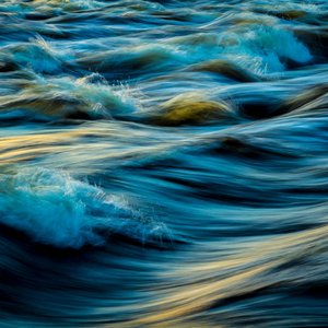 Capture of flowing ocean waves in motion, showcasing the vibrant colors and dynamic movement of water.