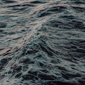 Energized ocean waves showcasing motion and power during sunset.