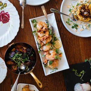 An overhead view of a beautifully arranged dining table featuring various gourmet dishes, perfect for a culinary experience.